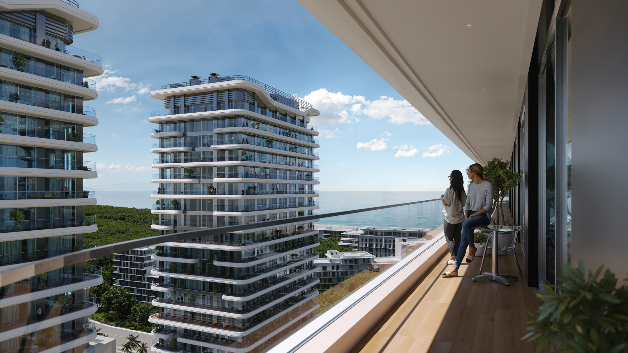 Two women enjoy the ocean view from their Sky Park apartment balcony.