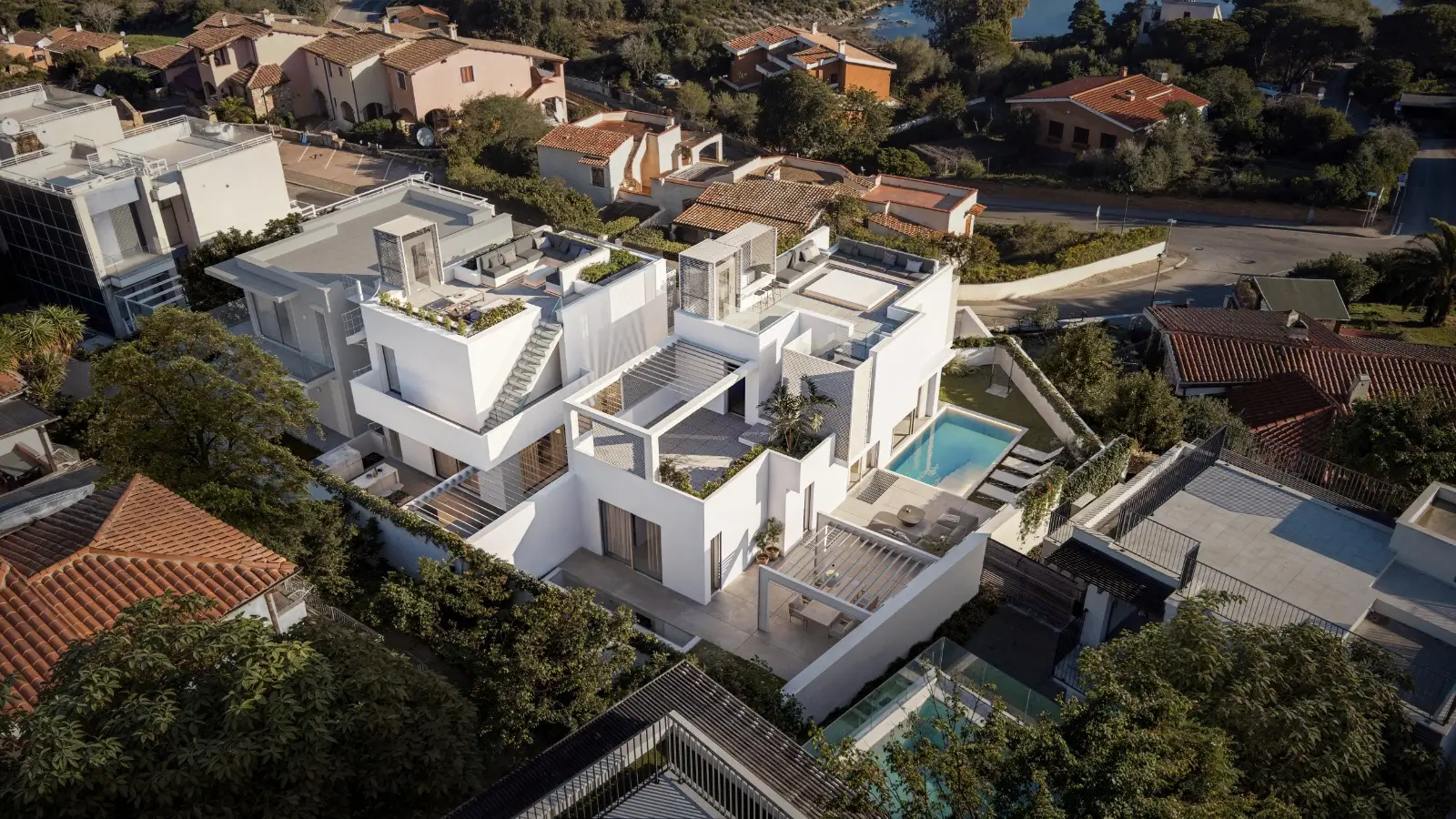 Aerial view of Villa Dumas, a modern white villa with a pool and rooftop terraces.